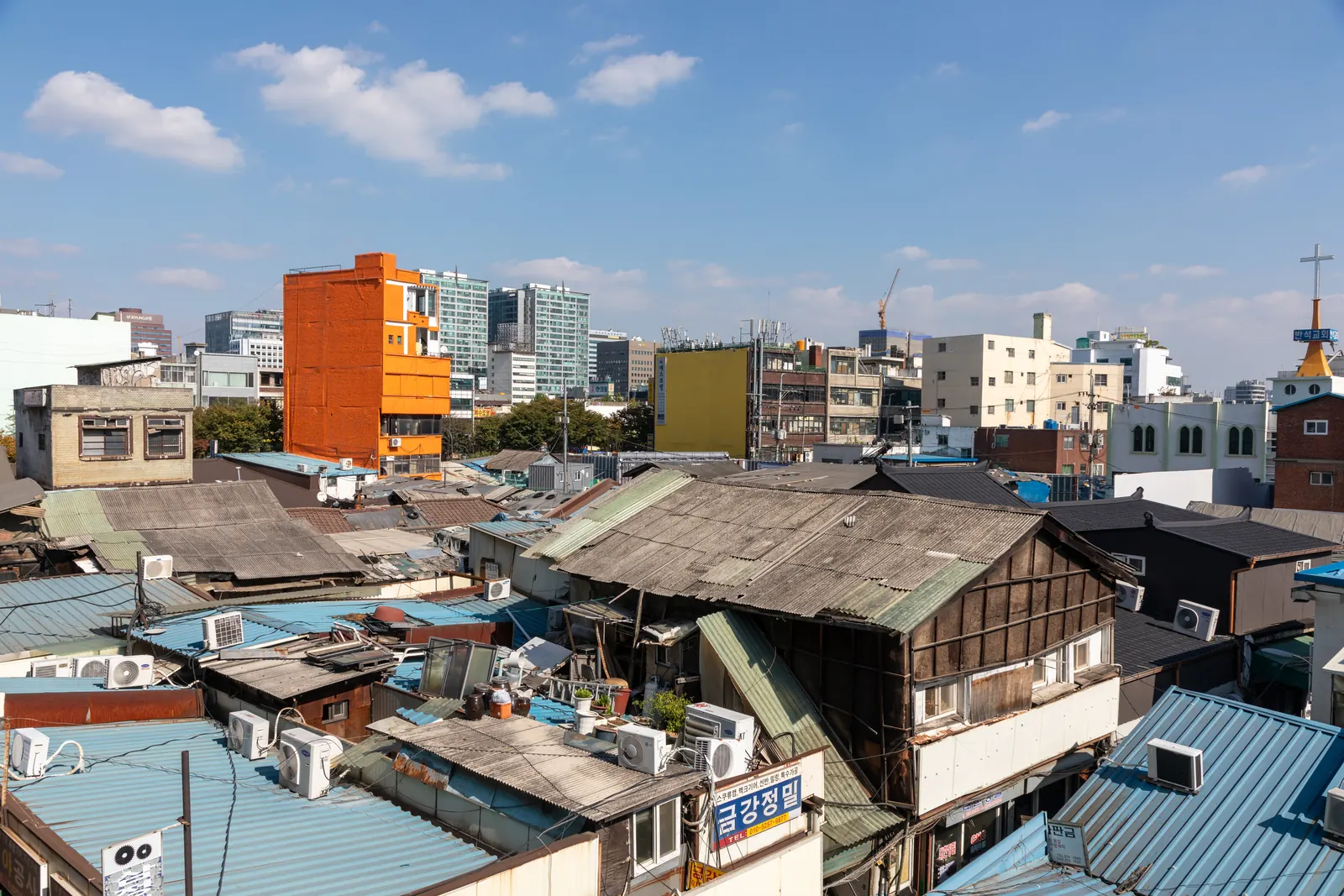 Rooftops and a bright orange building in Euljiro, Seoul, seen from Daelim Plaza