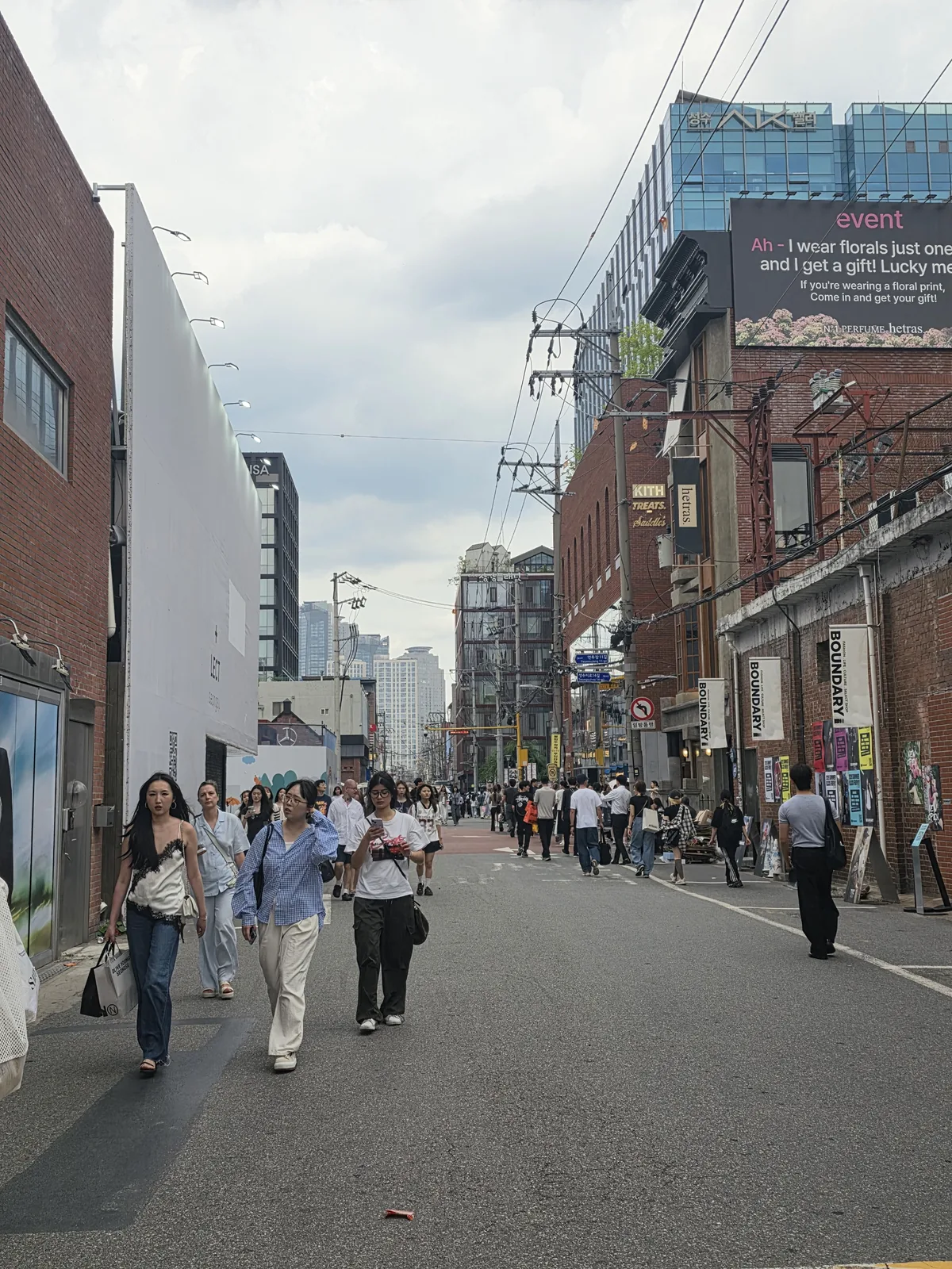 Pedestrians and brick storefronts on a daytime street in Seongsu-dong, Seoul